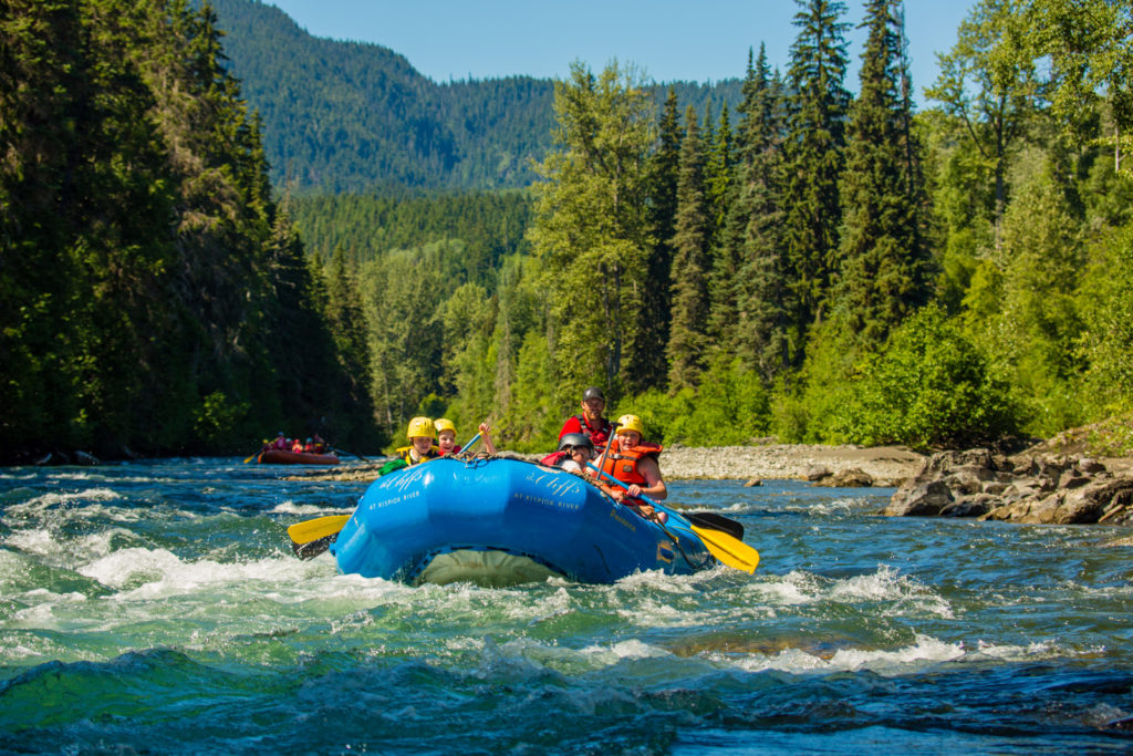 Riding rapids in a dinghy on the Kispiox Rivier